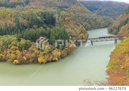 A train running on the Tadami Line in fall foliage A train running on the Tadami Line in fall foliage 96227679