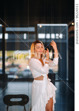 Beautiful smiling girl in a white dress dancing in the gym Beautiful smiling girl in a white dress dancing in the gym 96228311