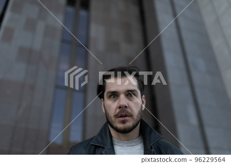 depressed man outside stands thoughtfully looking away depressed man outside stands thoughtfully looking away 96229564
