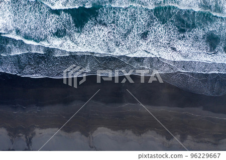 Aerial view of Atlantic ocean waves washing black sandy beach Aerial view of Atlantic ocean waves washing black sandy beach 96229667
