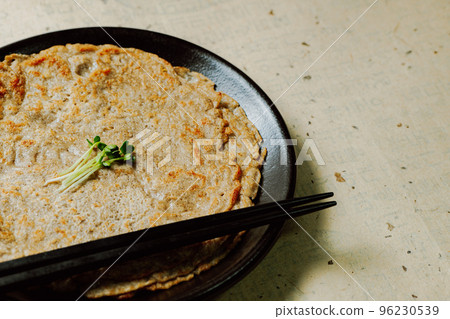 Korean food buckwheat pancake dish on a black plate Korean food buckwheat pancake dish on a black plate 96230539