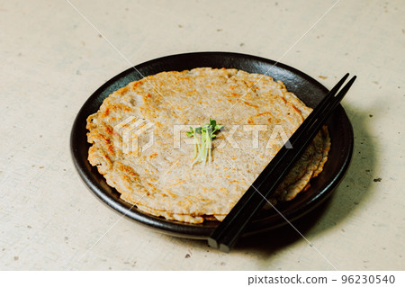 Korean food buckwheat pancake dish on a black plate Korean food buckwheat pancake dish on a black plate 96230540