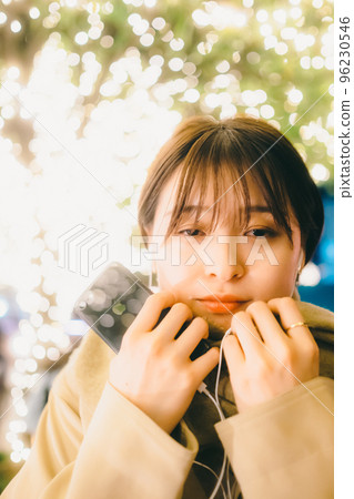 A picture of a woman waiting while listening to music on Christmas Day A picture of a woman waiting while listening to music on Christmas Day 96230546