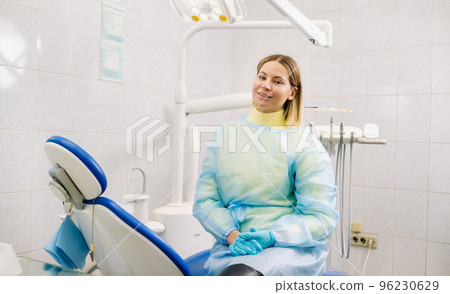 a female dentist sits in her dental office after work a female dentist sits in her dental office after work 96230629