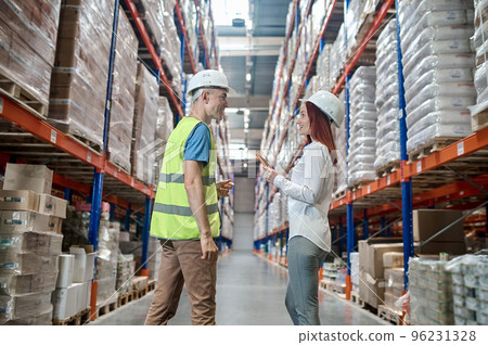Joyous supervisor communicating with a warehouse worker Joyous supervisor communicating with a warehouse worker 96231328