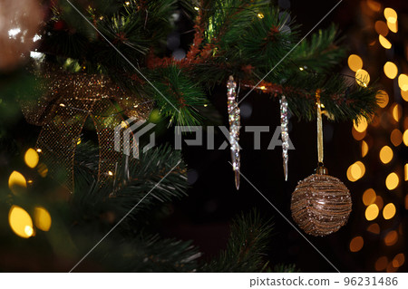Decorated branch of a Christmas tree on a blurred background. Decorated branch of a Christmas tree on a blurred background. 96231486
