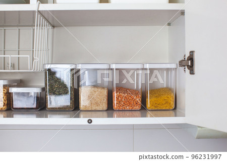 Storage ideas in the kitchen. White box and basket. Shelf order system. Storage ideas in the kitchen. White box and basket. Shelf order system. 96231997