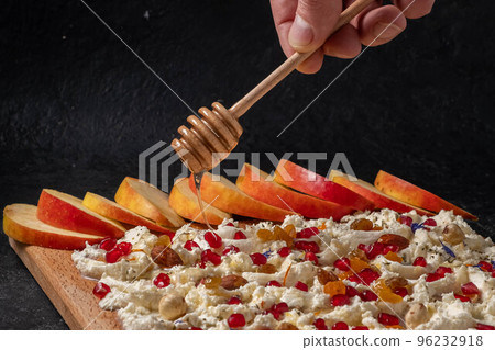 Trendy sweet butter board. Cooking process.man's hand sprinkle with 96232918