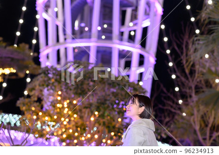 A woman enjoying winter illuminations 96234913