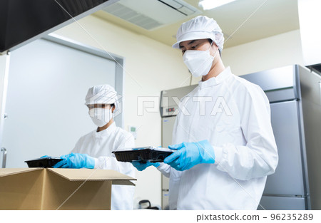 Cooking staff packing food into cardboard boxes School lunch center Bento shop Cooking staff packing food into cardboard boxes School lunch center Bento shop 96235289
