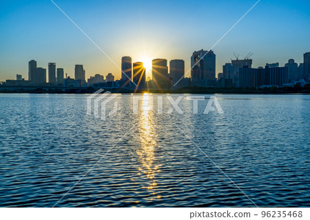 Umeda buildings and the sunrise seen from the Yodo River in Osaka City 96235468
