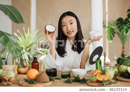 Blogger or content creator asian woman preparing natural cosmetics at home Blogger or content creator asian woman preparing natural cosmetics at home 96235524