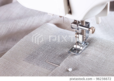 Modern sewing machine presser foot and item of clothes. Sewing process, handmade, hobby, business Modern sewing machine presser foot and item of clothes. Sewing process, handmade, hobby, business 96236672