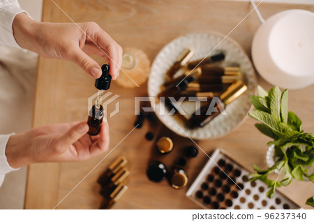 Close-up of female hands holding a bottle of essential oil, Aromatherapy Close-up of female hands holding a bottle of essential oil, Aromatherapy 96237340
