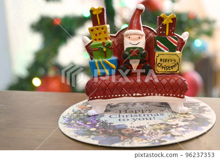 Santa sitting on a sofa with presents Santa sitting on a sofa with presents 96237353