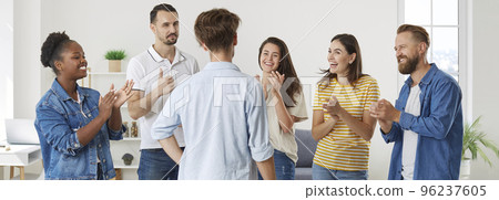 Group of happy people applauding their friend and congratulating him on great success Group of happy people applauding their friend and congratulating him on great success 96237605