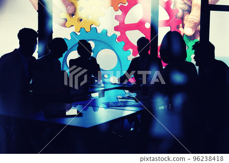 Business team connect pieces of gears. Teamwork, partnership and integration concept. double exposure with light effects Business team connect pieces of gears. Teamwork, partnership and integration concept. double exposure with light effects 96238418