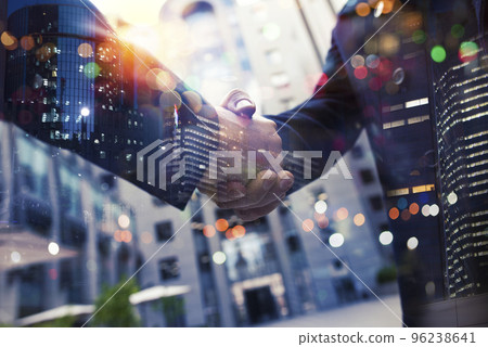 Handshaking business person in office. concept of teamwork and partnership. Handshaking business person in office. concept of teamwork and partnership. 96238641