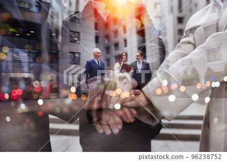 Business people putting their hands together. Concept of teamwork and partnership Business people putting their hands together. Concept of teamwork and partnership 96238752