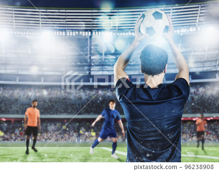 Soccer player ready to pass the ball at the stadium during a night match. Soccer player ready to pass the ball at the stadium during a night match. 96238908