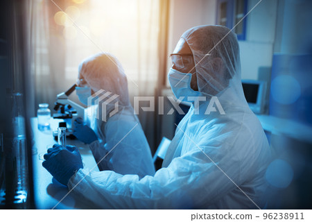 Doctor in the laboratory analyzes samples under a microscope. Pharmaceutical treatment concept. Doctor in the laboratory analyzes samples under a microscope. Pharmaceutical treatment concept. 96238911