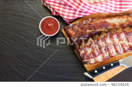 grilled pork ribs on a cutting board 96239026