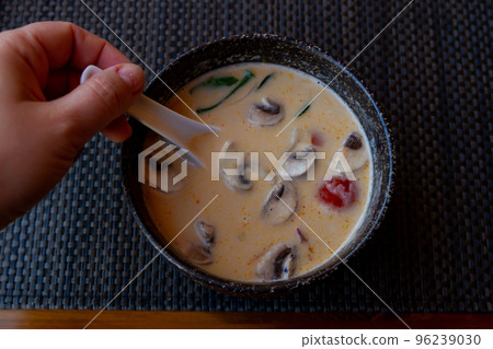 tom yam soup in a ceramic deep dish, liquid food in a restaurant, japanese soup with seafood tom yam has a man top view, a plate of Japanese cuisine soup with a ceramic white spoon tom yam soup in a ceramic deep dish, liquid food in a restaurant, japanese soup with seafood tom yam has a man top view, a plate of Japanese cuisine soup with a ceramic white spoon 96239030