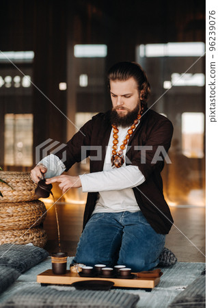 The tea master is preparing to hold a tea ceremony in the interior The tea master is preparing to hold a tea ceremony in the interior 96239076