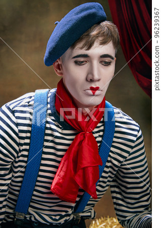 Closeup portrait of male mime artist expressing sadness and loneliness over dark retro circus backstage background. Concept of emotions, art, fashion, style 96239367