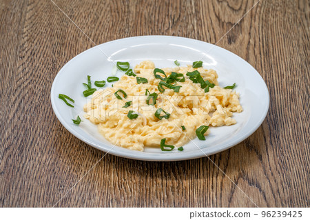 scrambled eggs with fresh green onions 96239425