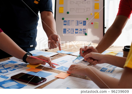 Group of ux developer and ui designer brainstorming about app interface design at modern office. Creative digital development agency 96239609