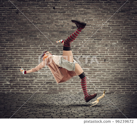 Funny clown slips on a banana peel. concept of unlucky 96239672