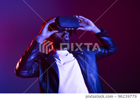 Man with VR glasses play with a virtual videogame Man with VR glasses play with a virtual videogame 96239779