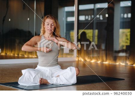 The girl does yoga and is in a state of meditation. The concept of a healthy lifestyle The girl does yoga and is in a state of meditation. The concept of a healthy lifestyle 96240030