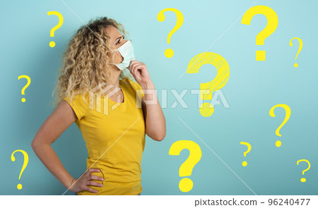 Blonde girl has doubt about covid19 corona virus. Cyan background. 96240477