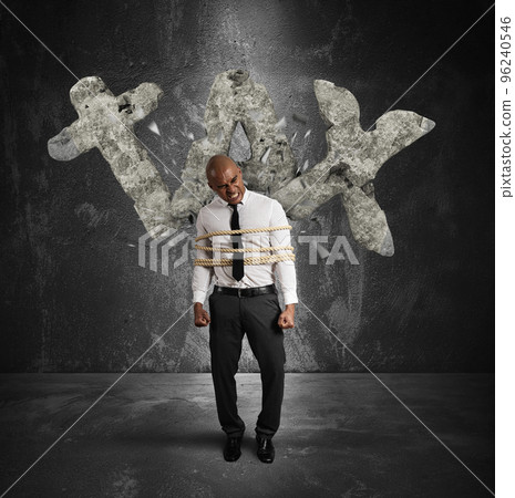 Tied businessman is crushed and oppressed by weight taxes 96240546