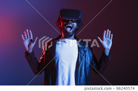 Man with VR glasses play with a virtual videogame 96240574