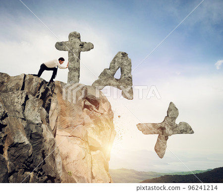 Businessmanthrows off the mountain the word TAX made of heavy rock Businessmanthrows off the mountain the word TAX made of heavy rock 96241214