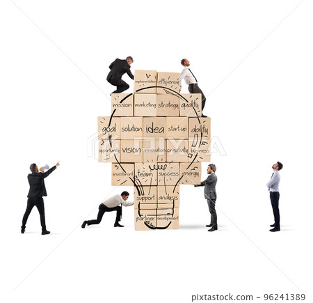 Building a new creative idea. Business person built together a big brick wall with drawn lightbulb 96241389