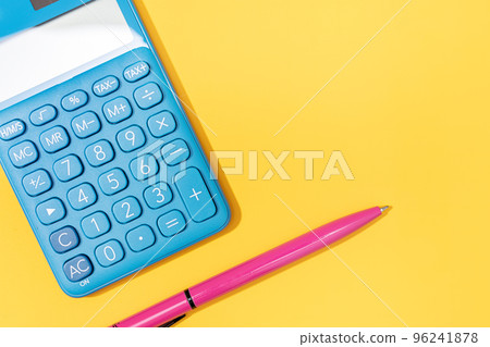 Flat lay of Calculator and pen on yellow background. Vibrant colors Copy space 96241878