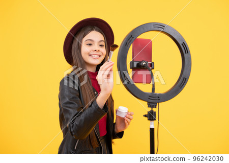 happy teen girl blogger use selfie led lamp and smartphone, makeup tutorial. happy teen girl blogger use selfie led lamp and smartphone, makeup tutorial. 96242030