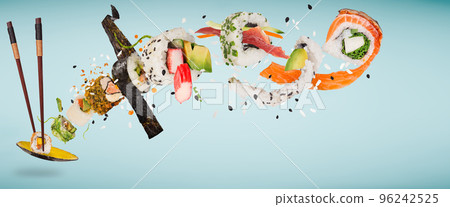 Pieces of delicious japanese sushi frozen in the air. Isolated on pastel blue background Pieces of delicious japanese sushi frozen in the air. Isolated on pastel blue background 96242525