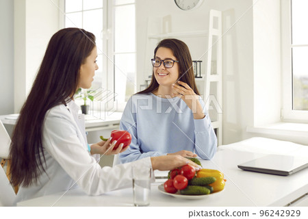 Dietitian giving dieting consultation to young woman who wants to lose some weight 96242929