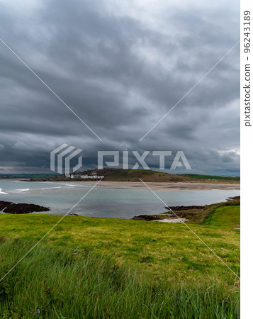 View of Clonakilty Bay. Thick grass. The coastline of the south of Ireland. Seaside landscape. Cloudy weather before a thunderstorm. View of Clonakilty Bay. Thick grass. The coastline of the south of Ireland. Seaside landscape. Cloudy weather before a thunderstorm. 96243189