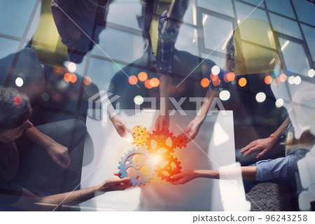 Business team connect pieces of gears. Teamwork, partnership and integration concept Business team connect pieces of gears. Teamwork, partnership and integration concept 96243258