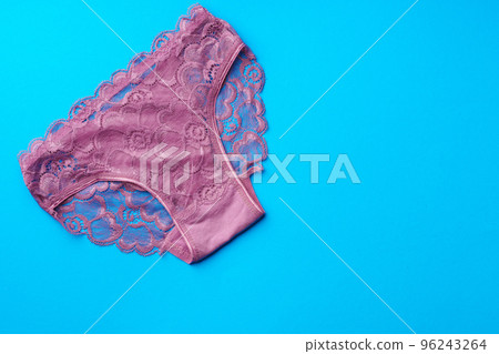 Women's panties on a blue background in studio 96243264