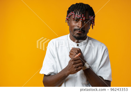 Young african man wearing casual clothes standing on yellow background Young african man wearing casual clothes standing on yellow background 96243353