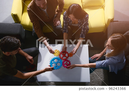 Business team connect pieces of gears. Teamwork, partnership and integration concept Business team connect pieces of gears. Teamwork, partnership and integration concept 96243366