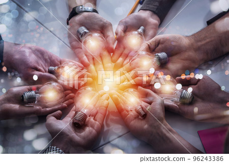 Teamwork and brainstorming concept with businessmen that share an idea with a lamp. Concept of startup Teamwork and brainstorming concept with businessmen that share an idea with a lamp. Concept of startup 96243386