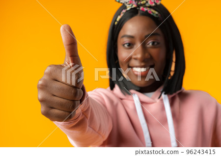 African young woman over isolated yellow background with thumbs up 96243415
